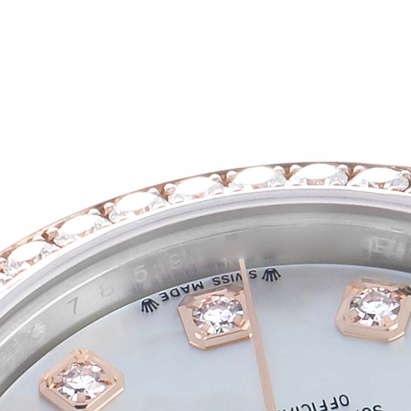 The image shows a close-up of the Rolex Datejust 279381 Women
s Steel and Gold (two tone) Mother of Pearl Dial watch face with diamond hour markers and a jeweled bezel.
