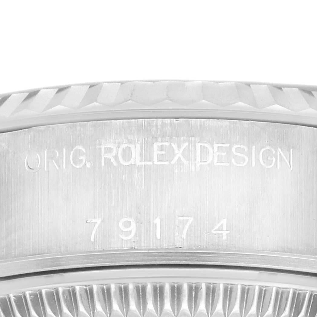 The image shows the side engraving of a Rolex Datejust 79174 Women's Stainless Steel Mother of Pearl Dial 79174 Women's Stainless Steel Mother of Pearl Dial case with the model number and "ORIG. ROLEX DESIGN."