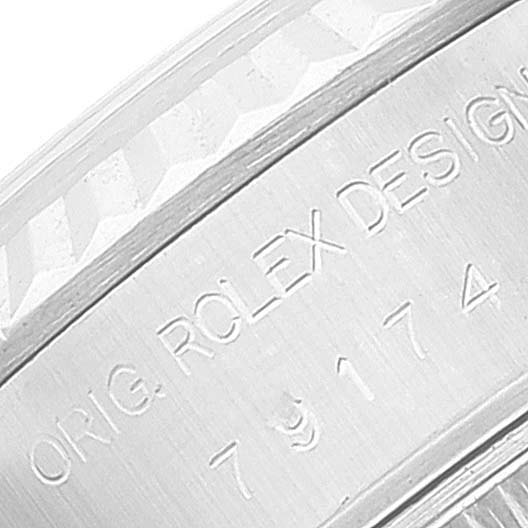 This image shows a close-up of the side of the case and bezel of a Rolex Datejust 79174 Women's Stainless Steel Silver Dial 79174 Women's Stainless Steel Silver Dial watch, displaying the engraved text.