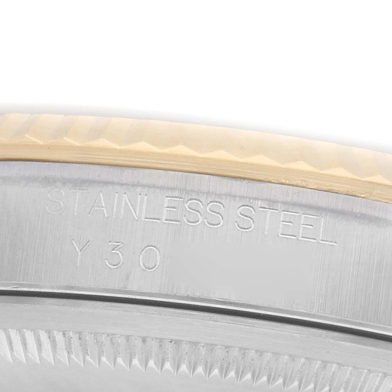 The image shows an angled view of a Rolex Datejust 16233 Men
s Steel and Gold (two tone) Silver Dial model, focusing on the stainless steel case back with engravings.