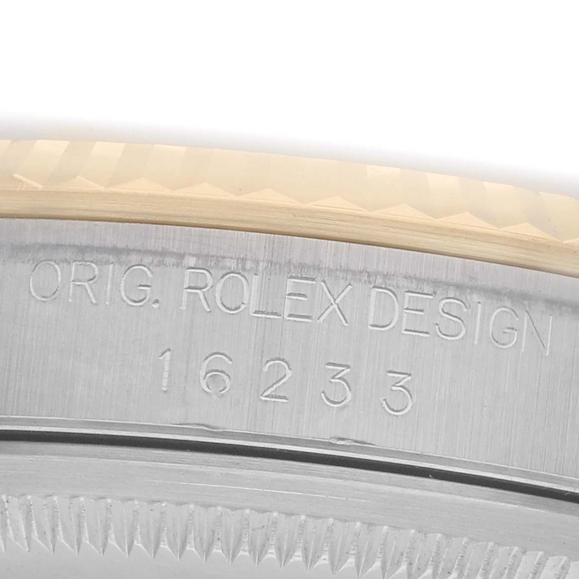 The image shows an angled view of the Rolex Datejust 16233 Men
s Steel and Gold (two tone) Silver Dial model
s engraved case-back and bezel edge.