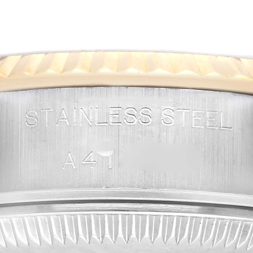 The image shows a close-up of the side of a Rolex Datejust 79173 Women's Steel and Gold (two tone) Champagne Dial 79173 Women's Steel and Gold (two tone) Champagne Dial, highlighting the stainless steel bezel and engraved details.