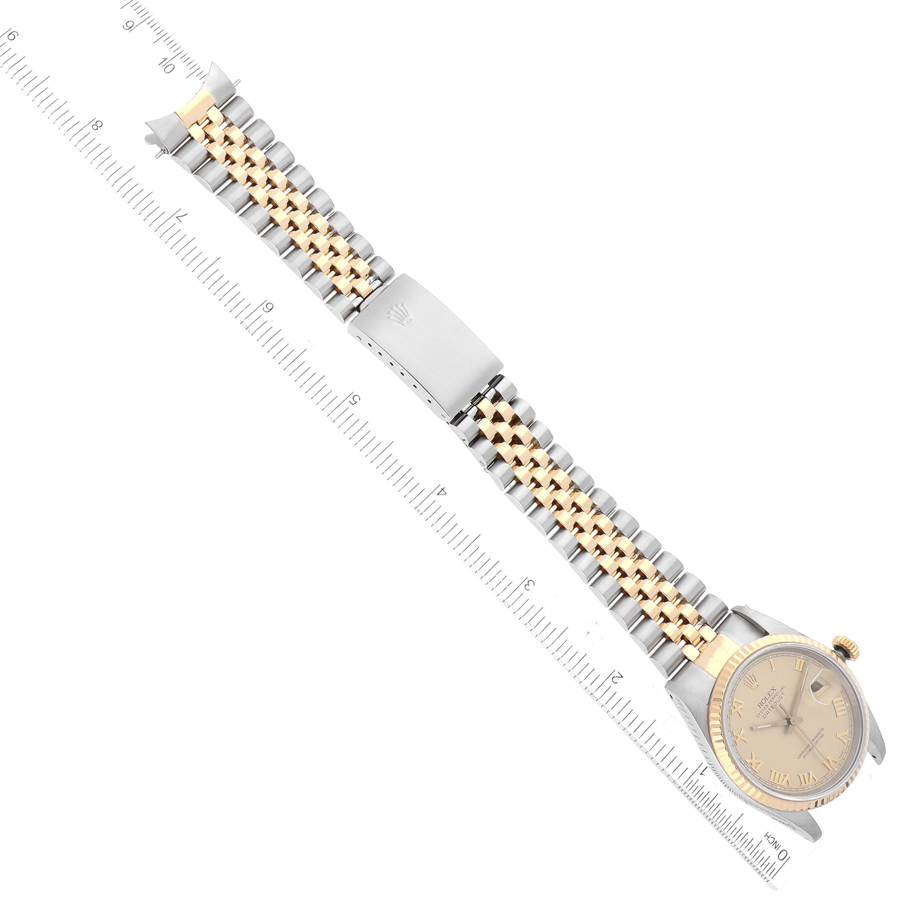 The image shows a Rolex Datejust 16233 Men's Steel and Gold (two tone) Champagne Dial 16233 Men's Steel and Gold (two tone) Champagne Dial watch laid flat with a two-tone bracelet, a clasp, and a ruler for scale.