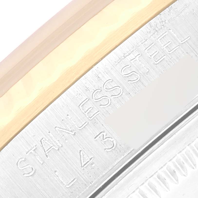 The image shows a close-up view of the caseback engraving on a Rolex Datejust 16233 Men's Steel and Gold (two tone) Champagne Dial 16233 Men's Steel and Gold (two tone) Champagne Dial watch, including "STAINLESS STEEL" text.