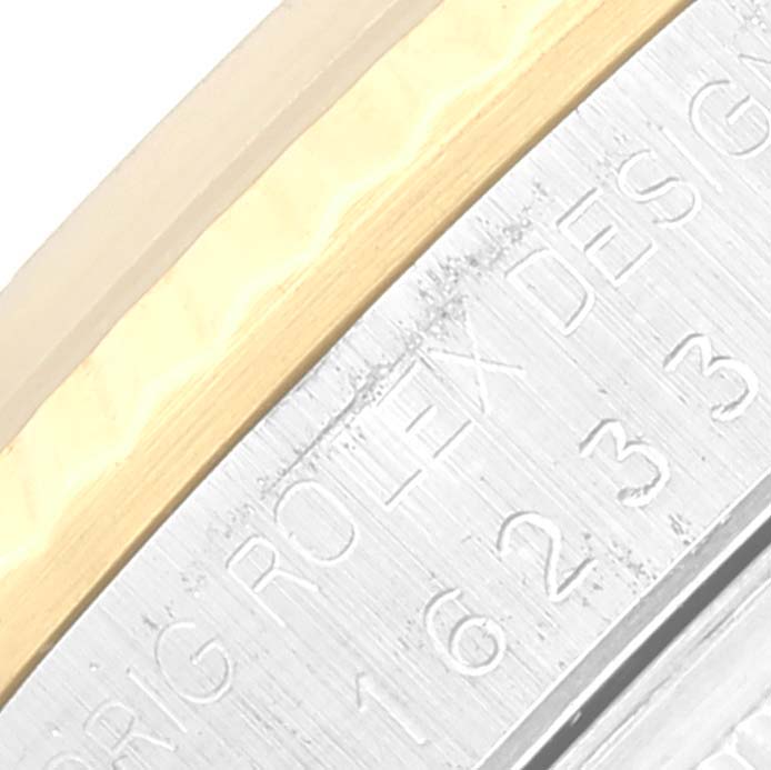 This image shows a close-up view of the engraved side of a Rolex Datejust 16233 Men's Steel and Gold (two tone) Champagne Dial 16233 Men's Steel and Gold (two tone) Champagne Dial watch case.