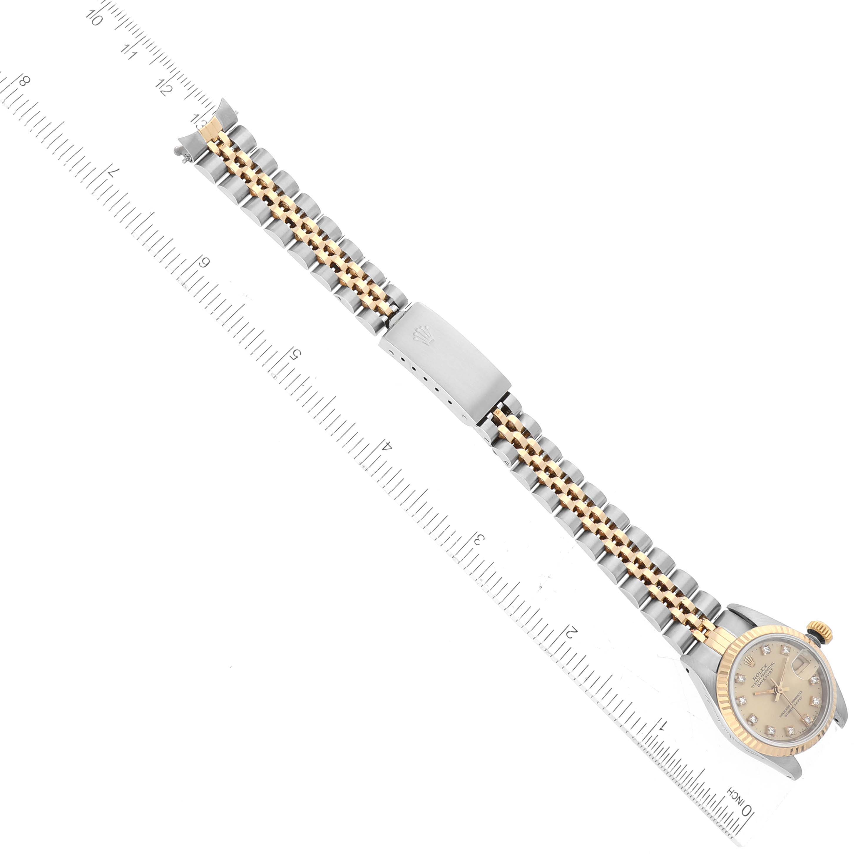 This image shows the Rolex Datejust 69173 Women's Steel and Gold (two tone) Champagne Dial 69173 Women's Steel and Gold (two tone) Champagne Dial watch model laying flat, with a focus on its bracelet length measured alongside a ruler.