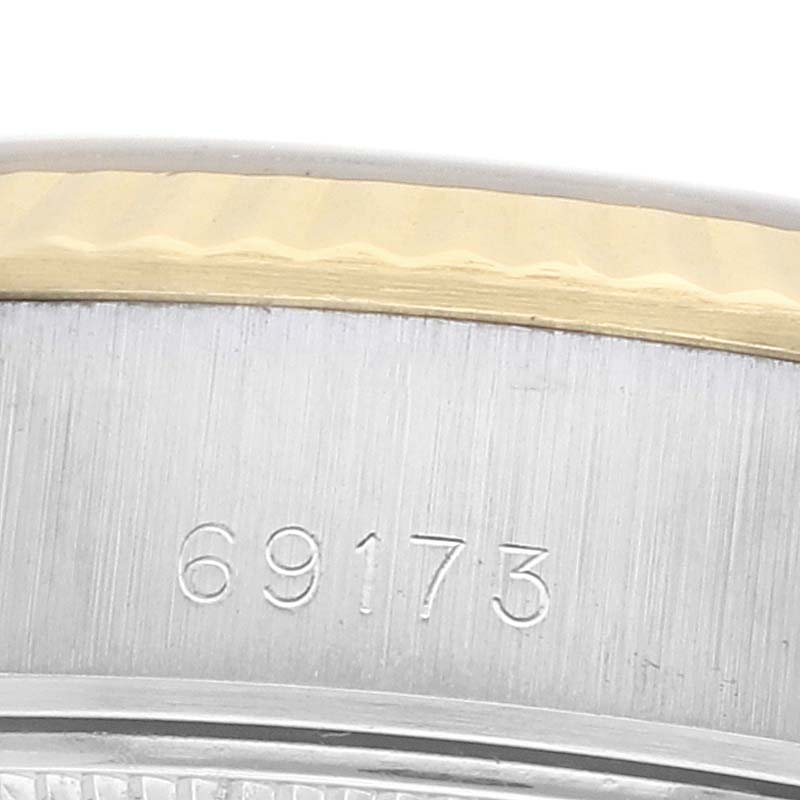 The image shows a close-up of the case side of a Rolex Datejust 69173 Women
s Steel and Gold (two tone) Champagne Dial, highlighting the model number "69173" engraving.