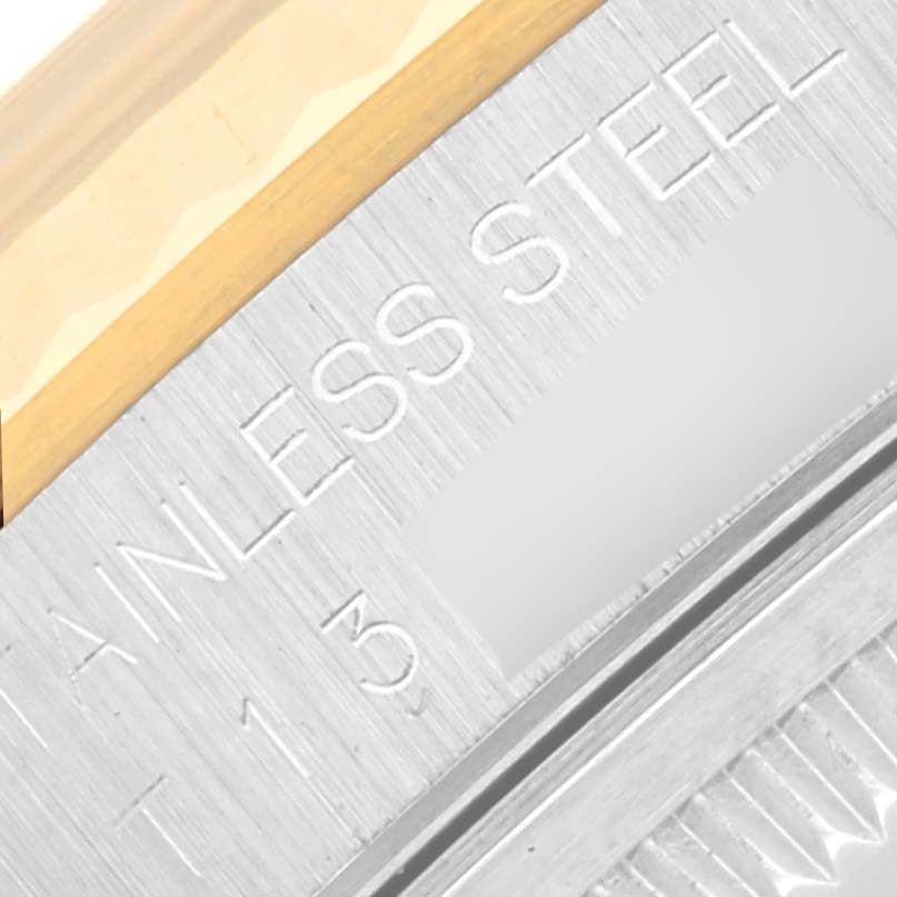 This close-up image shows part of the case and engravings on the Rolex Datejust 16233 Men's Steel and Gold (two tone) Champagne Dial 16233 Men's Steel and Gold (two tone) Champagne Dial watch's bezel edge.