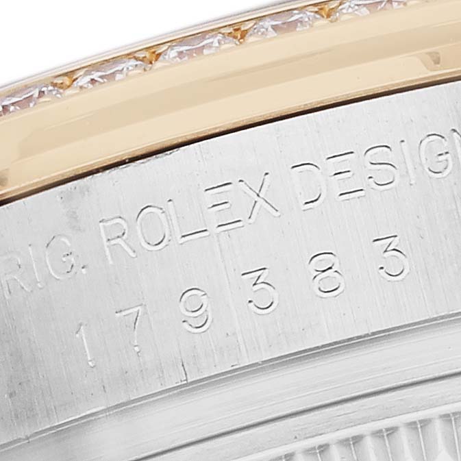 The image shows a close-up of the Rolex Datejust 179383 Women
s Steel and Gold (two tone) White Dial watch
s bezel and engraved side, highlighting the model details.