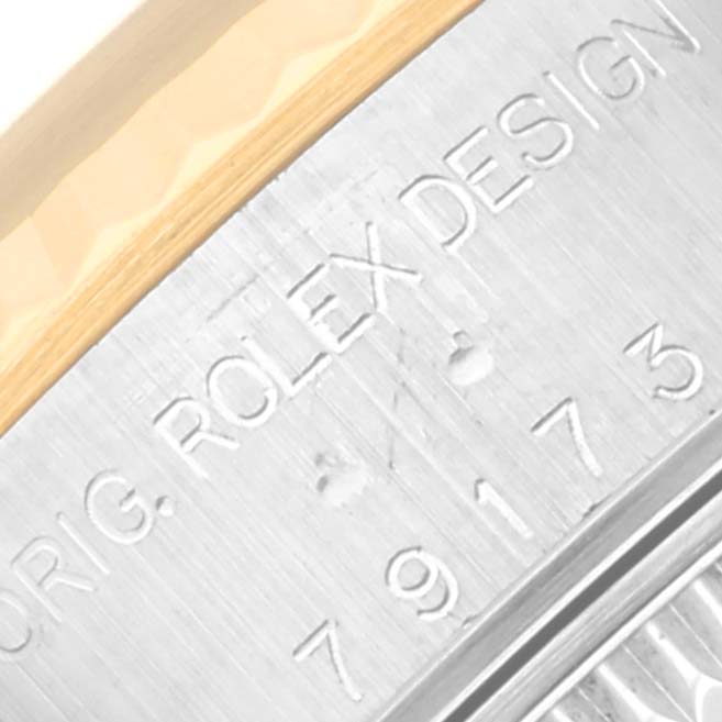 The image shows a close-up of the side engraving on a Rolex Datejust 79173 Women's Steel and Gold (two tone) Mother of Pearl Dial 79173 Women's Steel and Gold (two tone) Mother of Pearl Dial’s metal case.