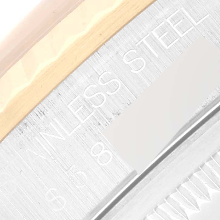 This close-up image shows the edge and part of the bezel of a Rolex Datejust 16233 Men's Steel and Gold (two tone) White Dial 16233 Men's Steel and Gold (two tone) White Dial watch, highlighting the "STAINLESS STEEL" text.