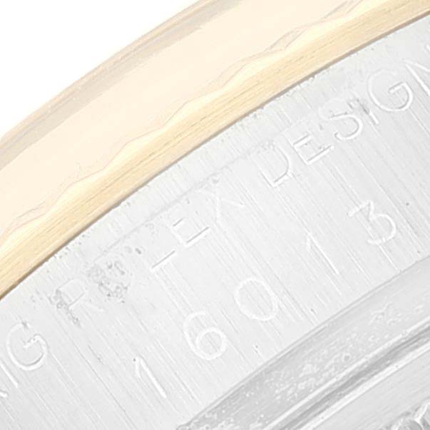 This close-up image shows part of the bezel and case side of a Vintage Collection model by Rolex.