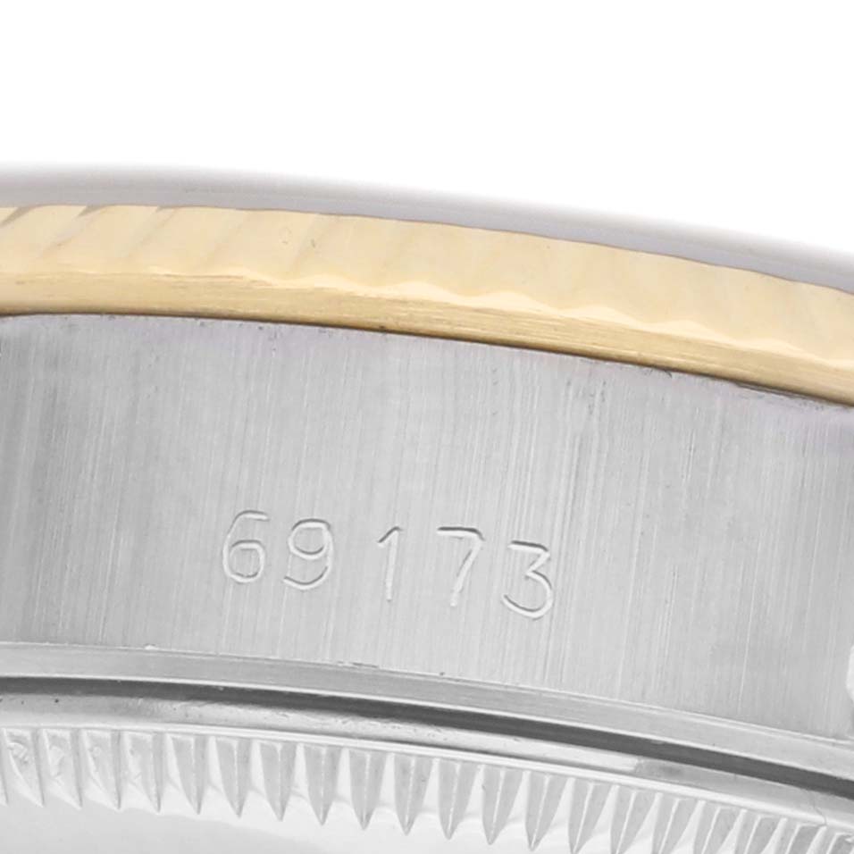 The image shows a close-up side view of the Rolex Datejust 69173 Women
s Steel and Gold (two tone) White Dial model, highlighting its case and part of the bezel with the model number.
