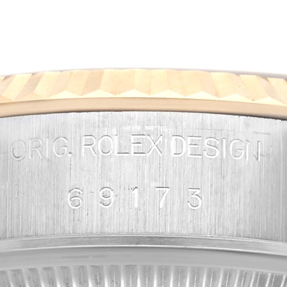 The image shows a close-up of the side of a Rolex Datejust 69173 Women's Steel and Gold (two tone) White Dial 69173 Women's Steel and Gold (two tone) White Dial, highlighting the bezel and engraved model number.