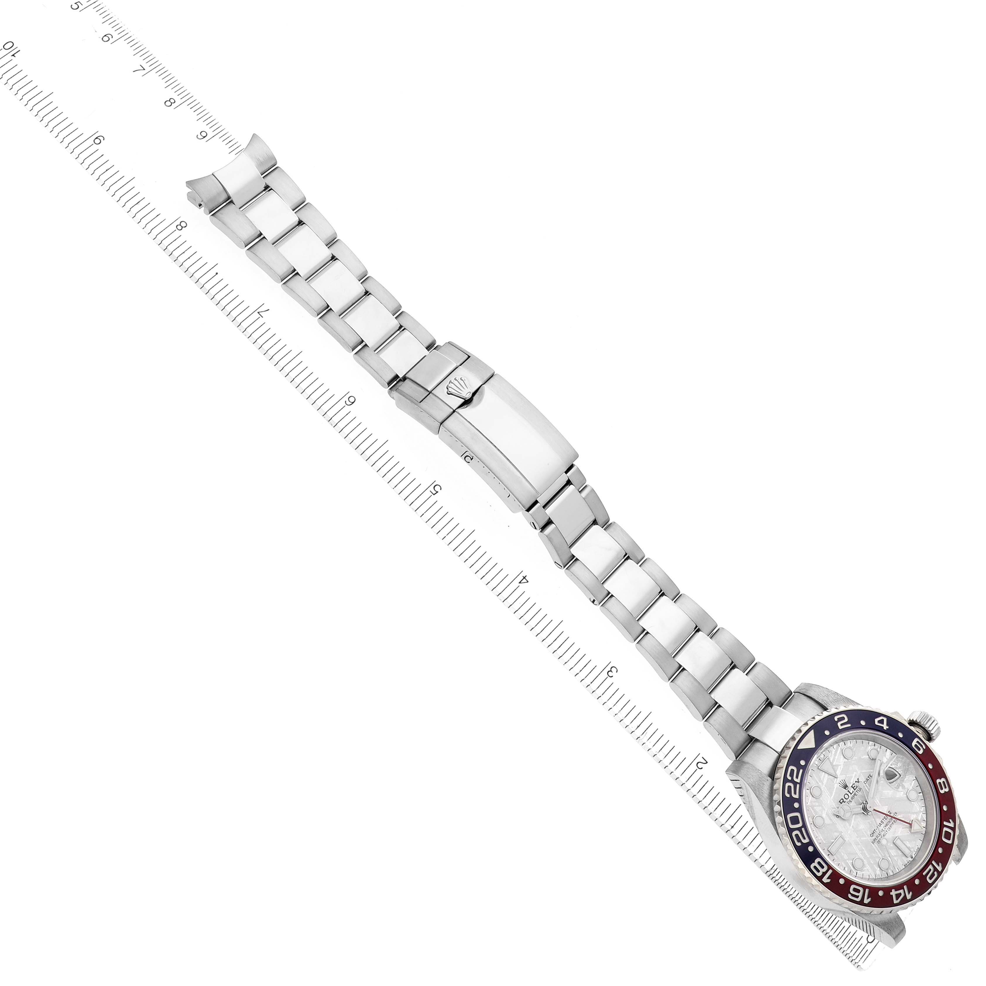 The image shows a Rolex GMT-Master 126719 Men
s White Gold Silver Dial watch laid flat, featuring the entire bracelet and bezel with a red and blue color scheme.