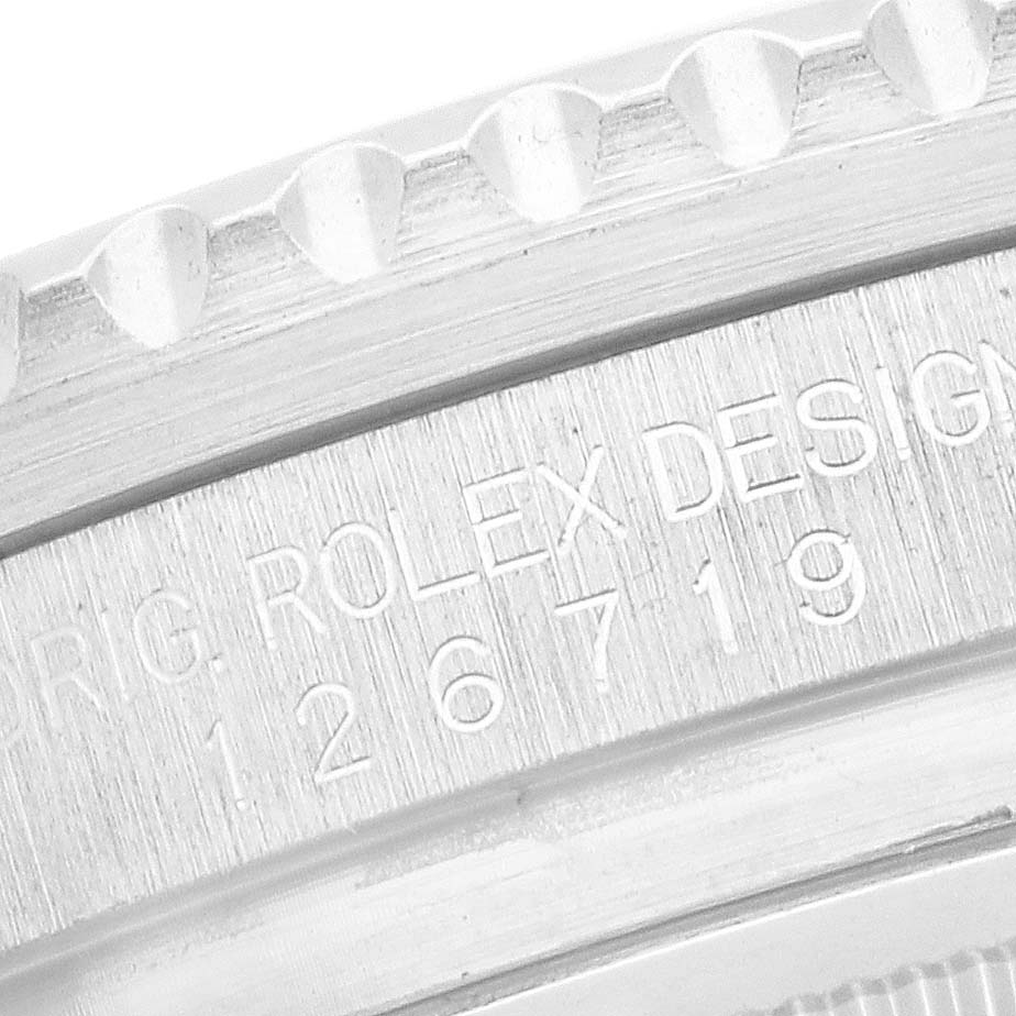 The image shows a close-up of the side engraved with "ROLEX DESIGN" on the GMT-Master model bezel.