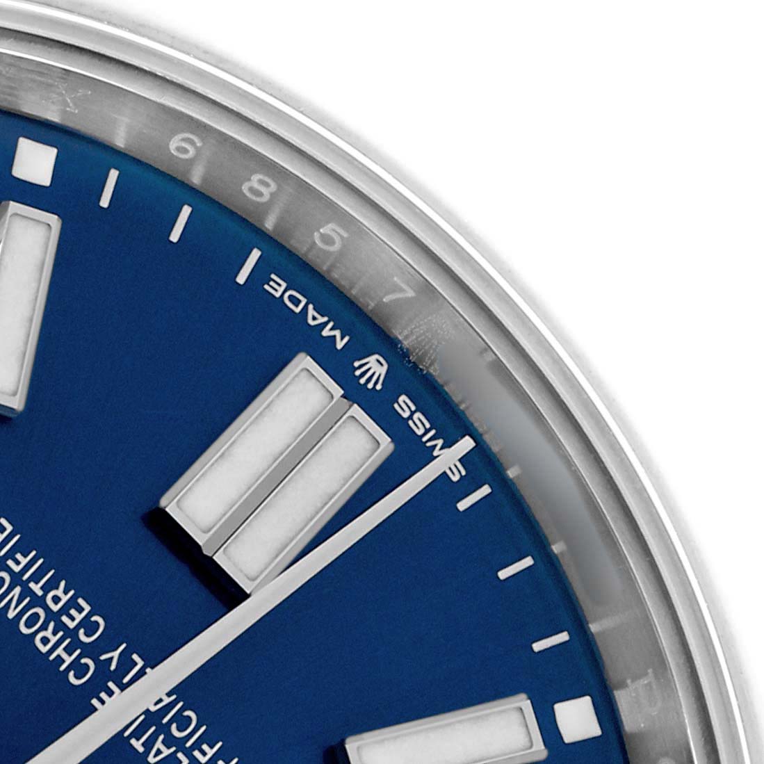 The image shows a close-up of the dial and partial bezel of a Rolex Oyster Perpetual 124300 Men
s Stainless Steel Blue Dial, focusing on the blue dial and hour markers.