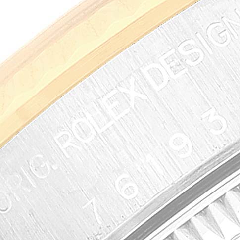 This close-up image shows the edge of the back casing of a Rolex Oyster Perpetual 76193 Women's Steel and Gold (two tone) Champagne Dial 76193 Women's Steel and Gold (two tone) Champagne Dial watch, highlighting the engraved text.