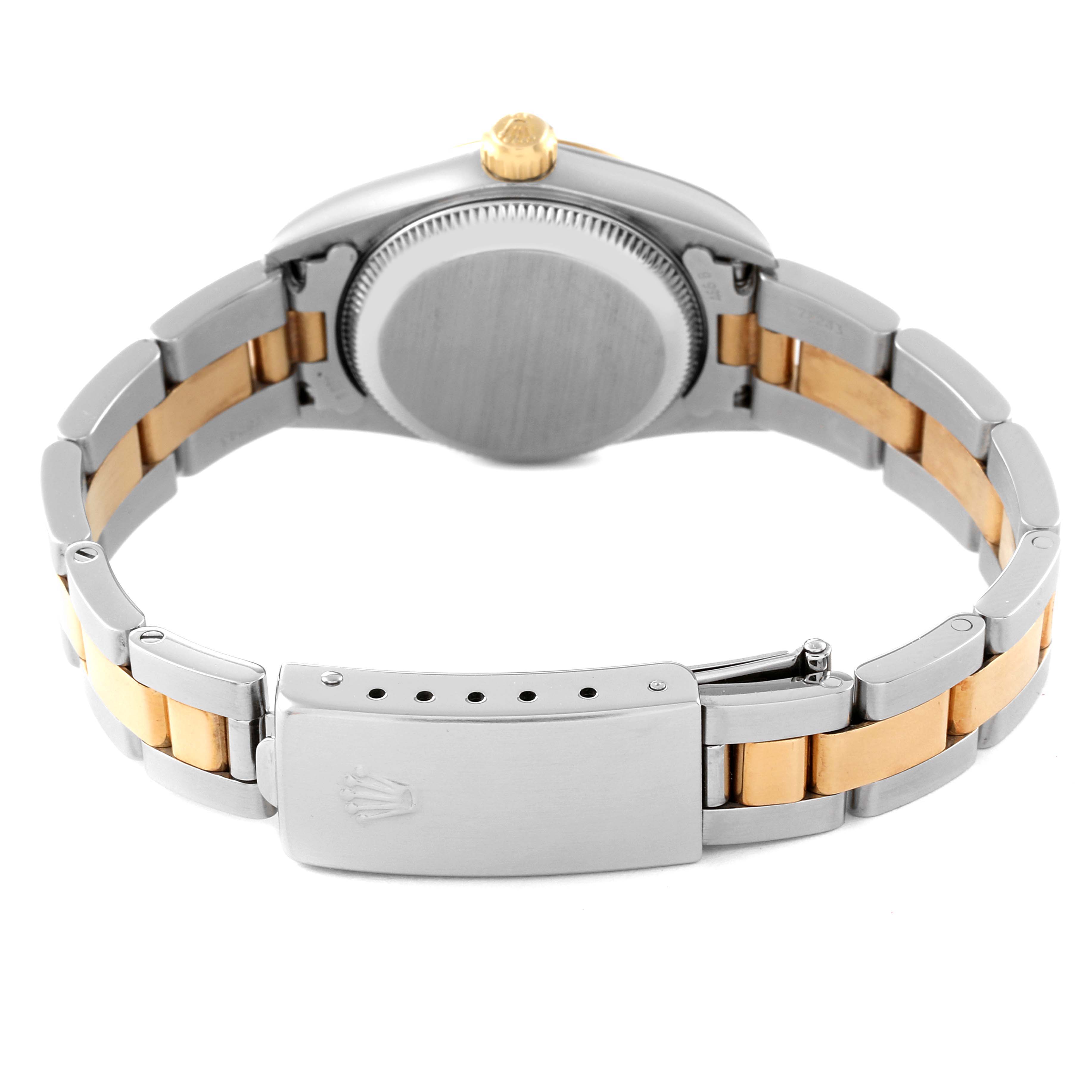 The image shows the back and clasp of the Rolex Oyster Perpetual 76193 Women's Steel and Gold (two tone) Champagne Dial 76193 Women's Steel and Gold (two tone) Champagne Dial watch, highlighting the two-tone metal bracelet and crown.