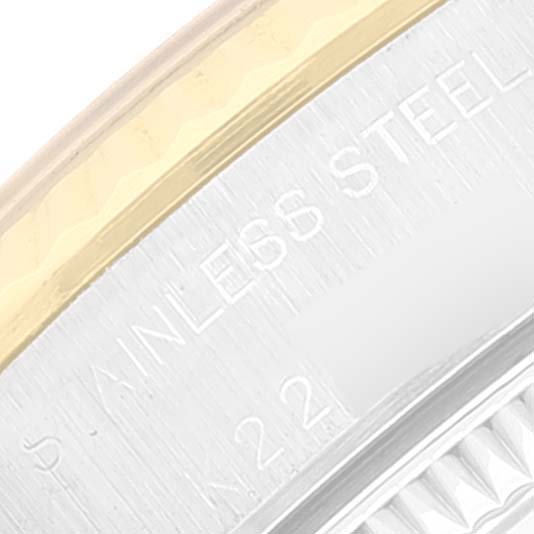 This image shows a close-up of the edge and bezel of a Rolex Oyster Perpetual 76193 Women's Steel and Gold (two tone) Champagne Dial 76193 Women's Steel and Gold (two tone) Champagne Dial watch, highlighting the "STAINLESS STEEL" engraving.