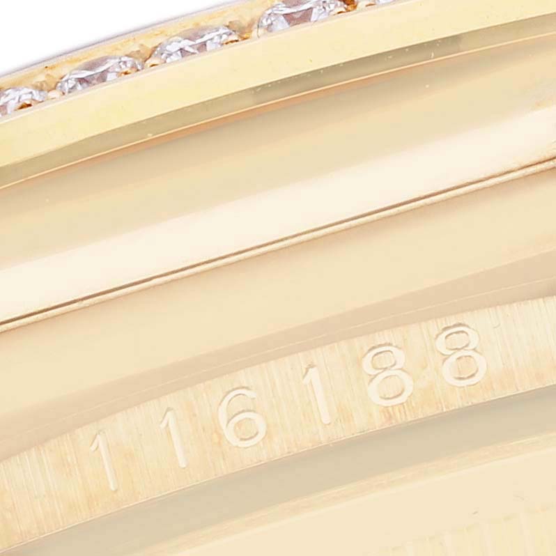 The image shows the edge of a Rolex President 116188 Men
s Yellow Gold Mother of Pearl Dial watch model, highlighting the bezel with diamonds and part of the serial number.
