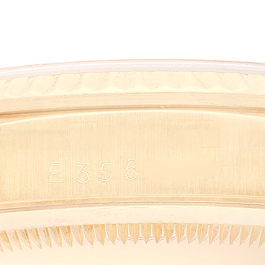 Close-up view of the bezel and serial number engraving of a Rolex President 18238 Men
s Yellow Gold Champagne Dial 18238 Men
s Yellow Gold Champagne Dial model watch.