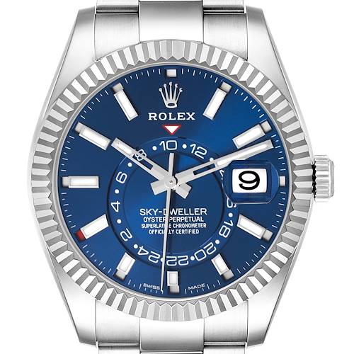 The Rolex Sky-Dweller is shown in a front view, highlighting its blue dial, bezel, hour markers, hands, and date display.