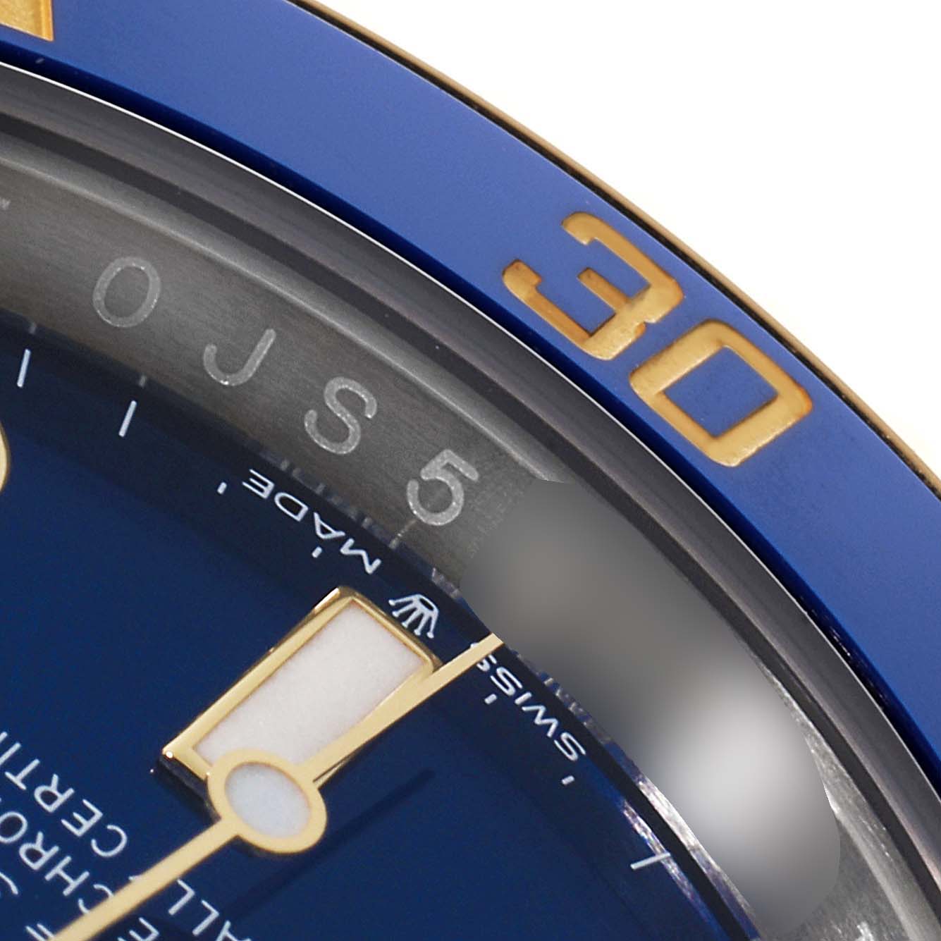 This image shows a close-up of the blue bezel and part of the dial of a Rolex Submariner 126613 Men
s Steel and Gold (two tone) Blue Dial 126613 Men
s Steel and Gold (two tone) Blue Dial watch.