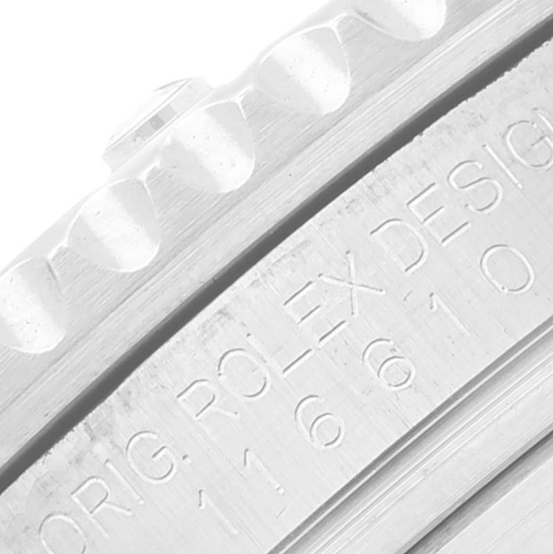 The image shows a close-up of the engraved bezel and case edge of a Rolex Submariner 116610LV Men's Stainless Steel Green Dial 116610LV Men's Stainless Steel Green Dial watch.