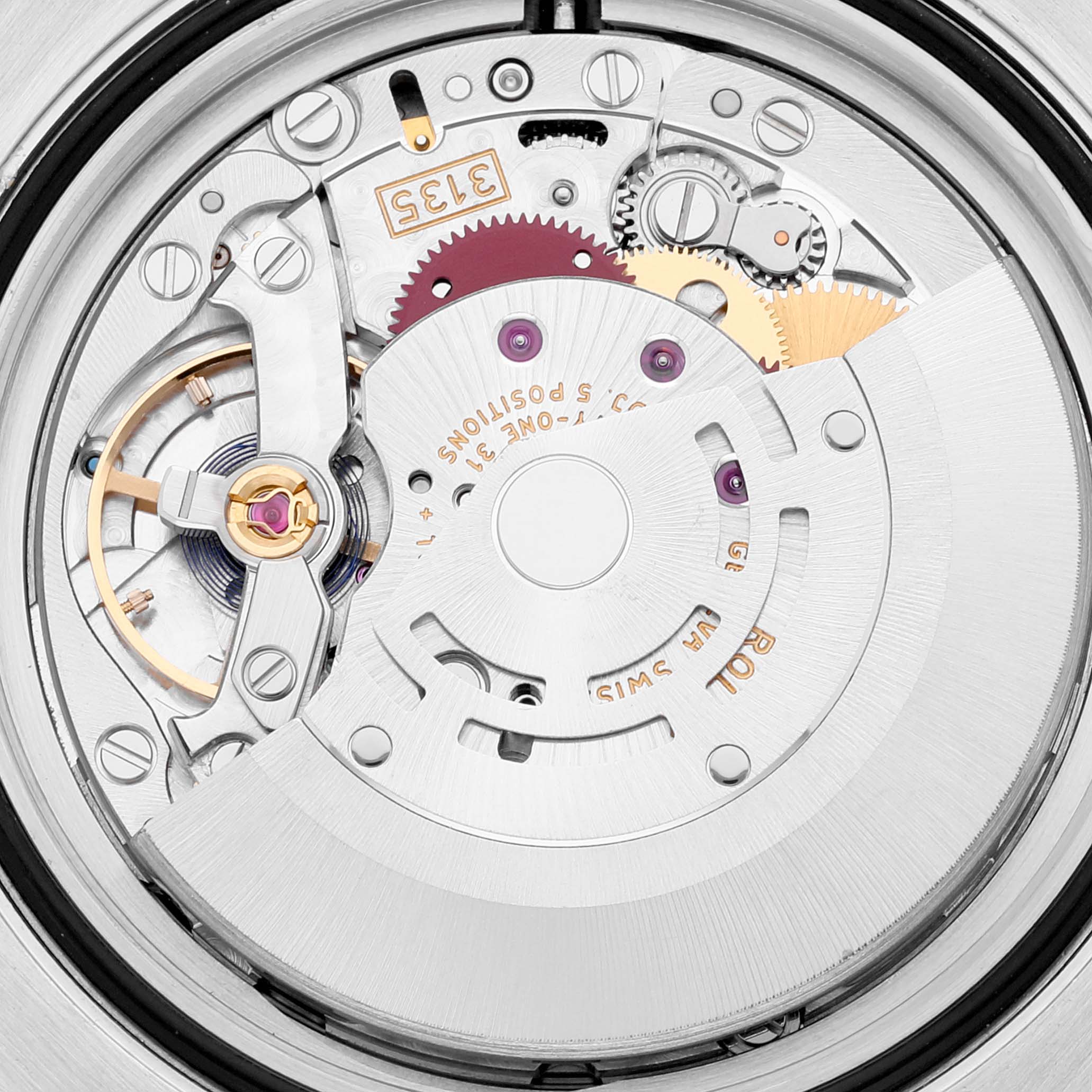This image shows a close-up view of the internal mechanism of a Rolex Submariner 116610LV Men's Stainless Steel Green Dial 116610LV Men's Stainless Steel Green Dial watch, highlighting gears and components.