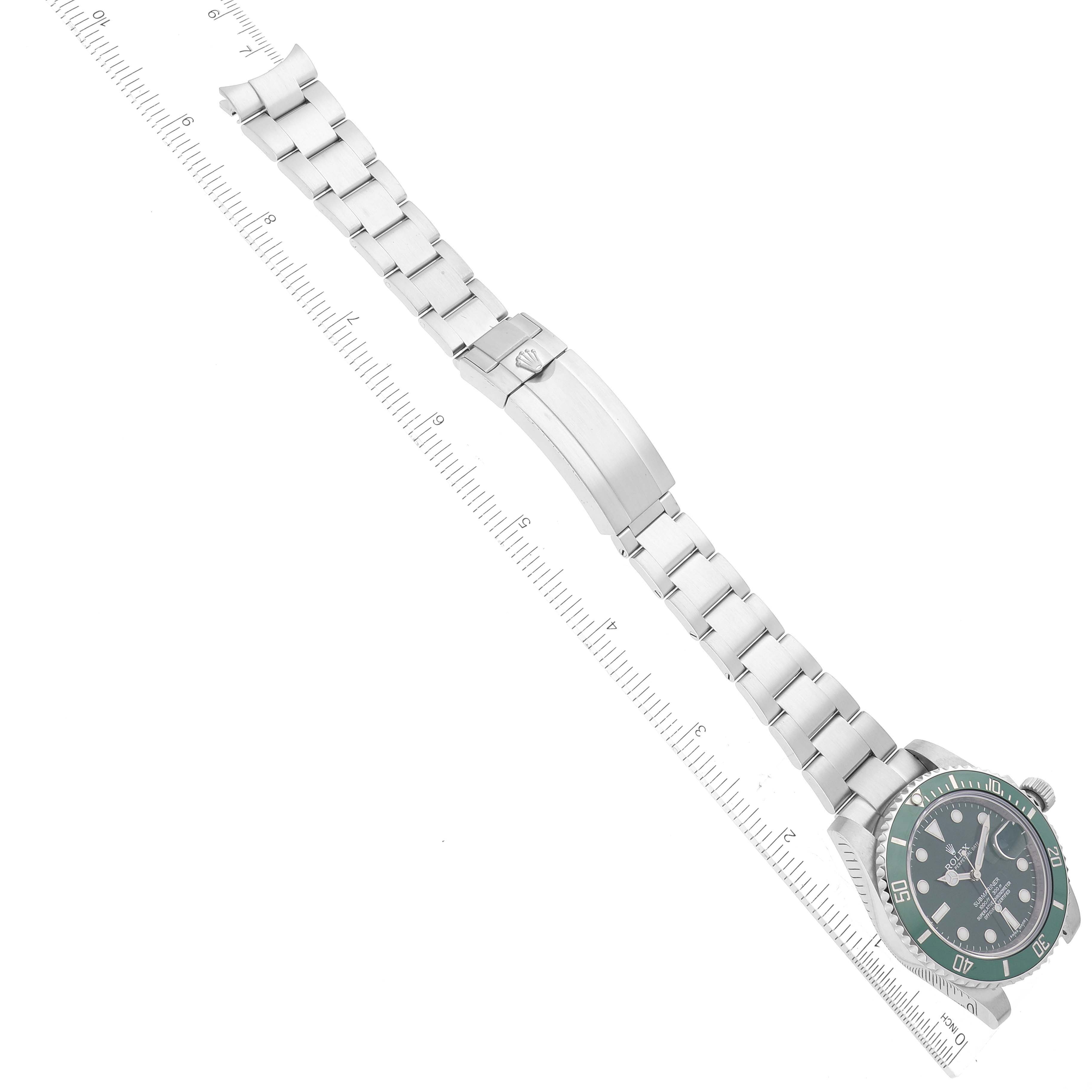 The image shows a Rolex Submariner 116610LV Men's Stainless Steel Green Dial 116610LV Men's Stainless Steel Green Dial watch, including the face, bezel, bracelet, and clasp, angled diagonally with a measuring scale.