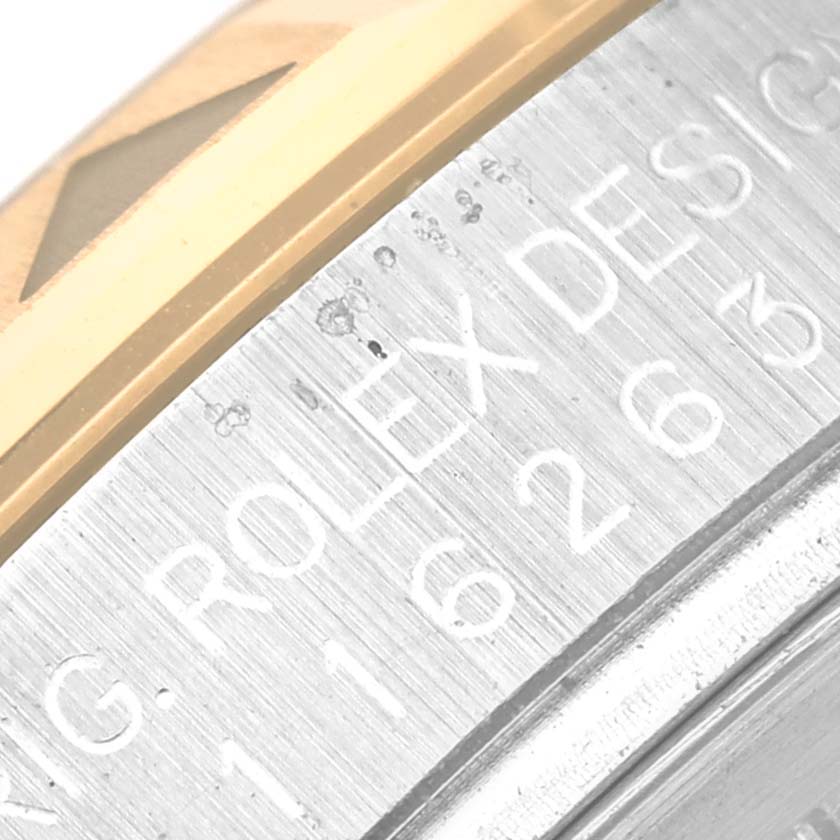 The image shows a close-up of the bezel and engraved side of a Rolex Turn-o-Graph 116263 Men's Steel and Gold (two tone) Black Dial 116263 Men's Steel and Gold (two tone) Black Dial watch.