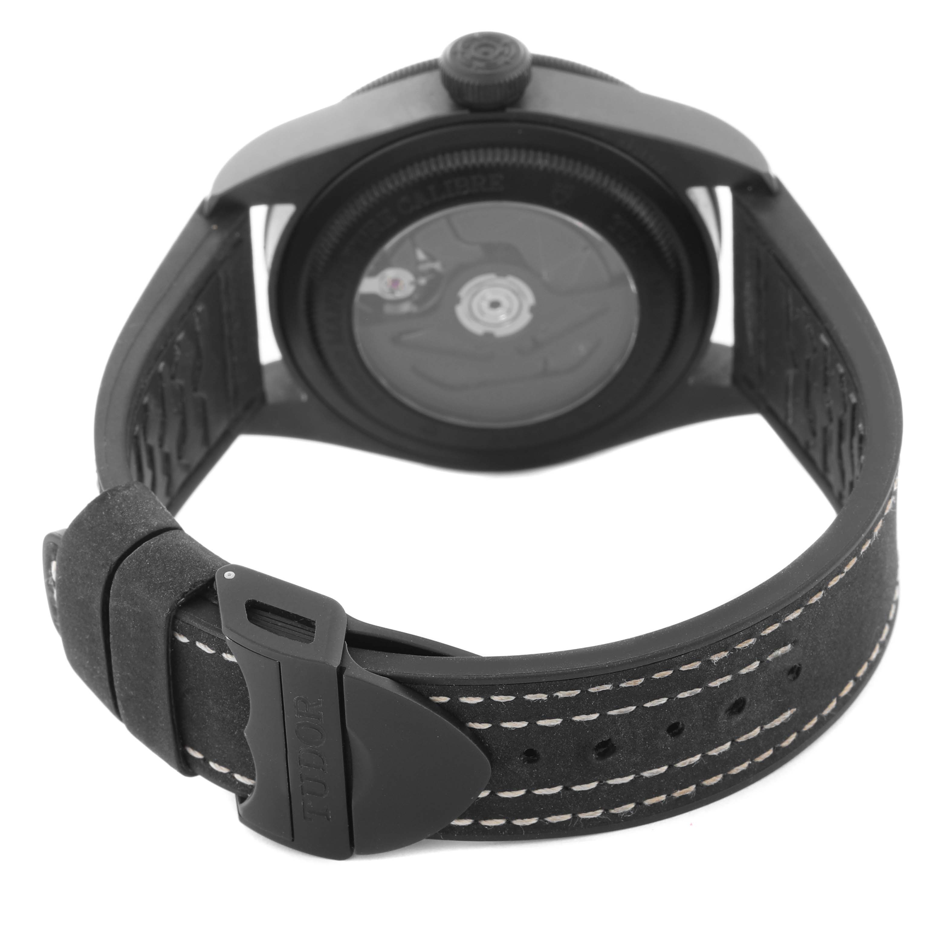 The image shows the Tudor Heritage Black Bay 79210CNU Men's Ceramic Black Dial 79210CNU Men's Ceramic Black Dial watch from the back, highlighting the movement and strap buckle.