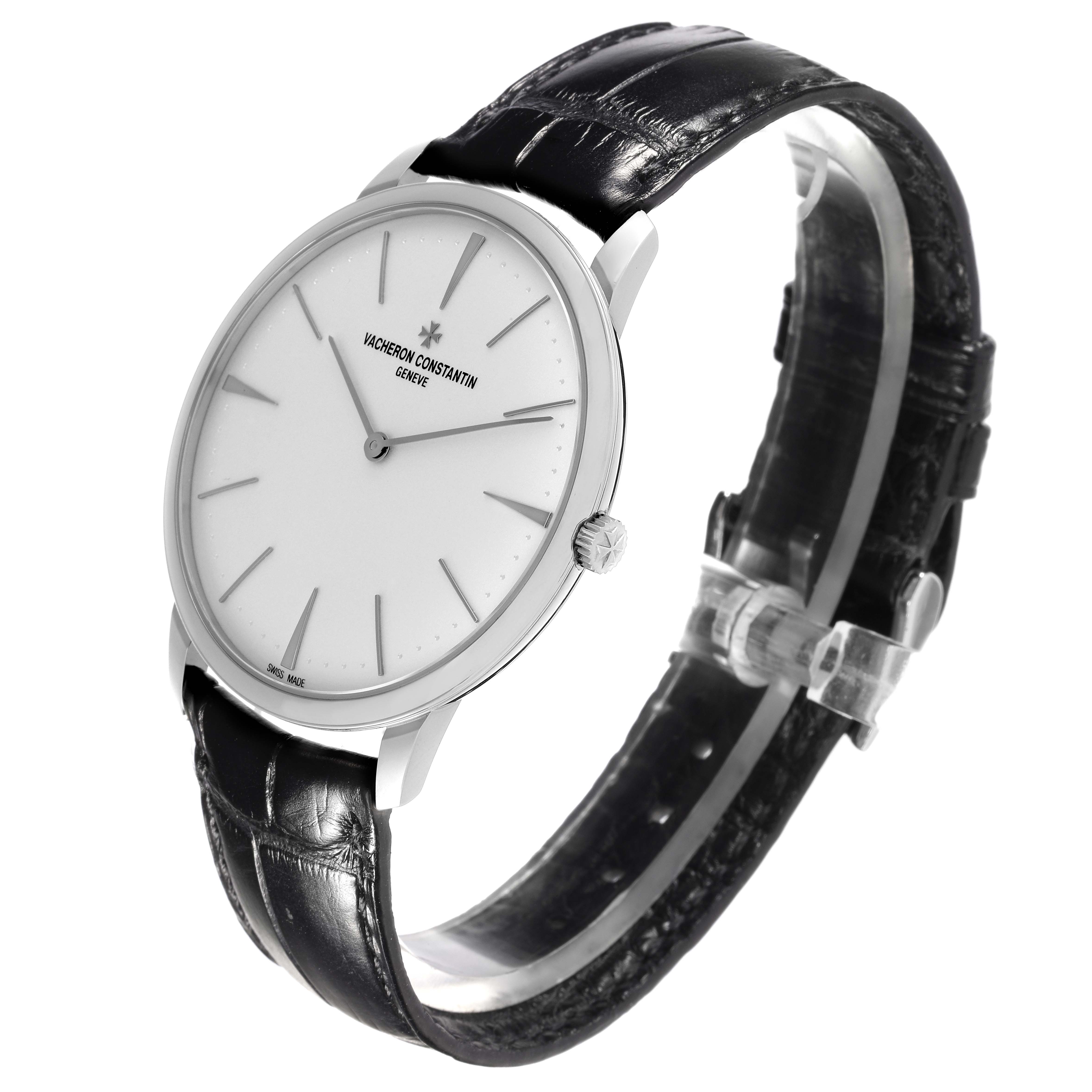 The Vacheron Constantin Patrimony 81180/000G Men's White Gold Silver Dial 81180/000G Men's White Gold Silver Dial watch is shown at an angle highlighting the face, bezel, crown, and part of the leather strap.