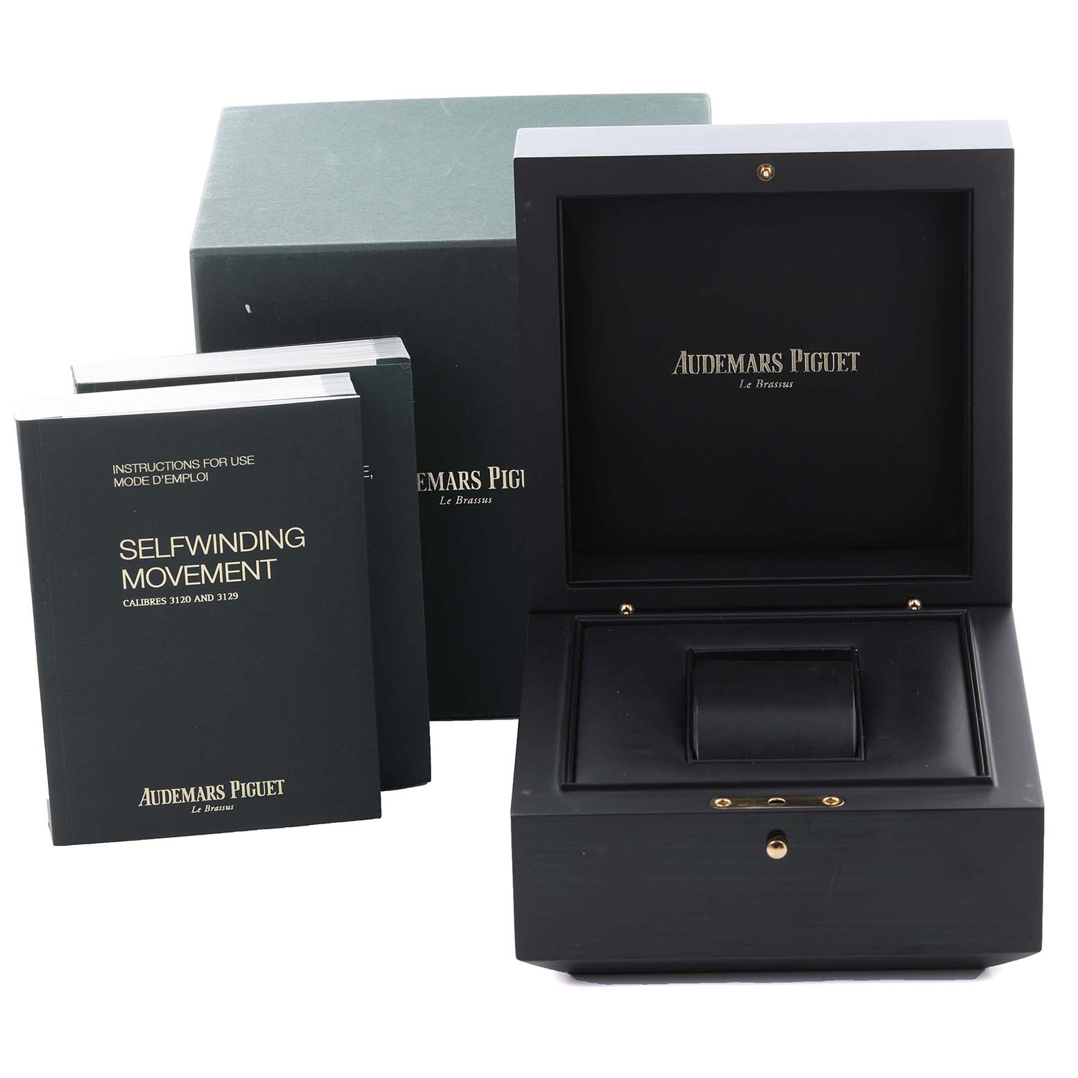 The image shows the packaging and instruction manuals for the Audemars Piguet Royal Oak 15450ST.OO.1256ST.01 Men's Stainless Steel Silver Dial 15450ST.OO.1256ST.01 Men's Stainless Steel Silver Dial, including a watch box and booklets.