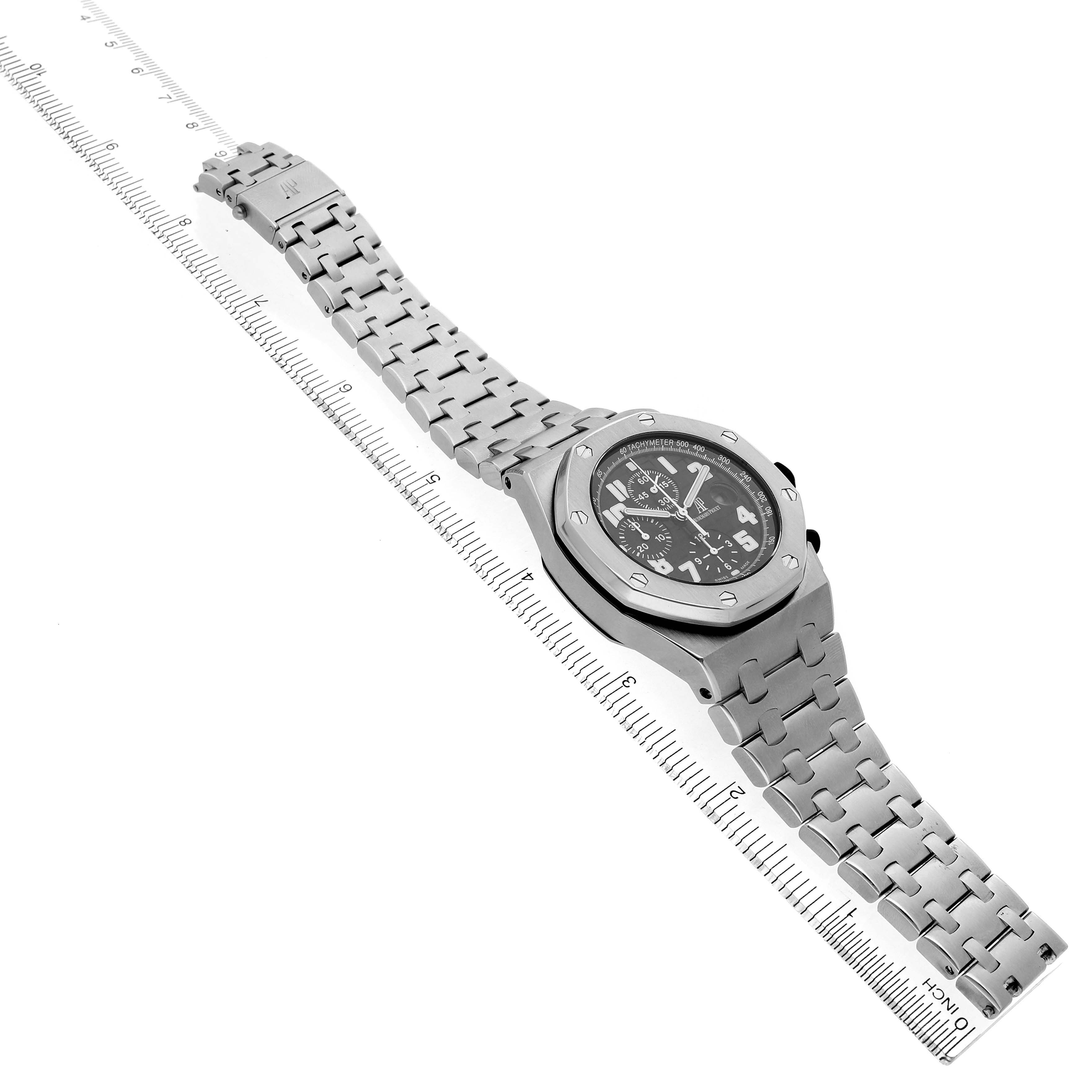 The Audemars Piguet Royal Oak Offshore 26170ST Men's Stainless Steel Black Dial watch is shown at a tilted angle, displaying the face, case, and steel bracelet alongside a ruler.