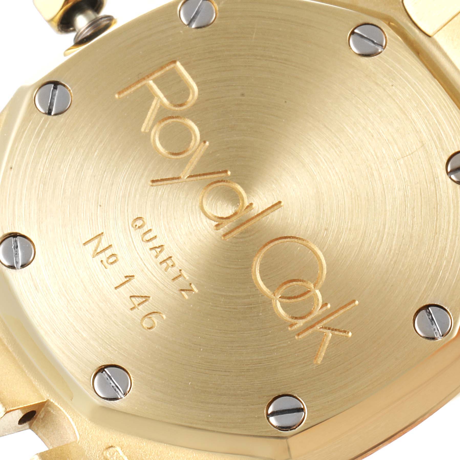 The image shows the case back of a Royal Oak watch by Audemars Piguet, displaying the model name and serial number.