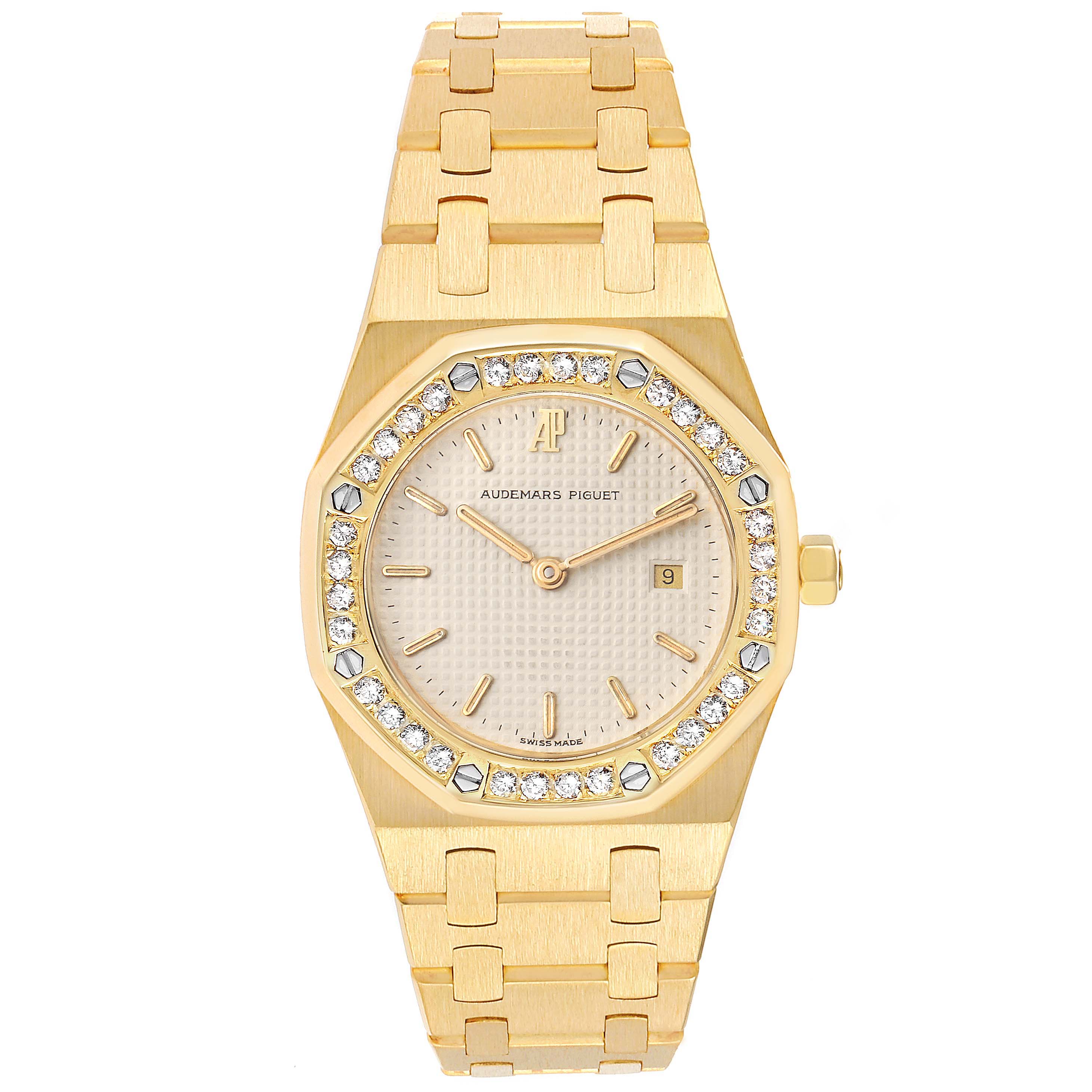 This image shows a front view of an Audemars Piguet Royal Oak 56271BA Women
s Yellow Gold Beige Dial 56271BA Women
s Yellow Gold Beige Dial watch, highlighting its gold bracelet, bezel with diamonds, and dial.