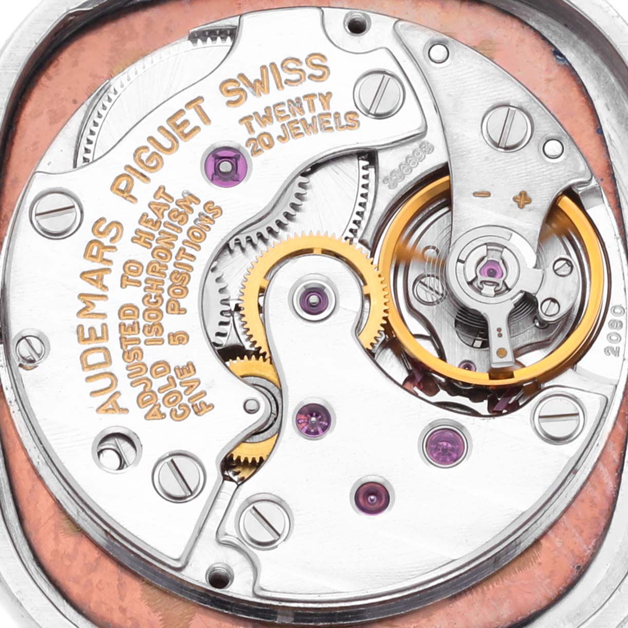 The image shows a close-up of the movement of a Vintage Audemars Piguet watch, featuring gears and jewels.