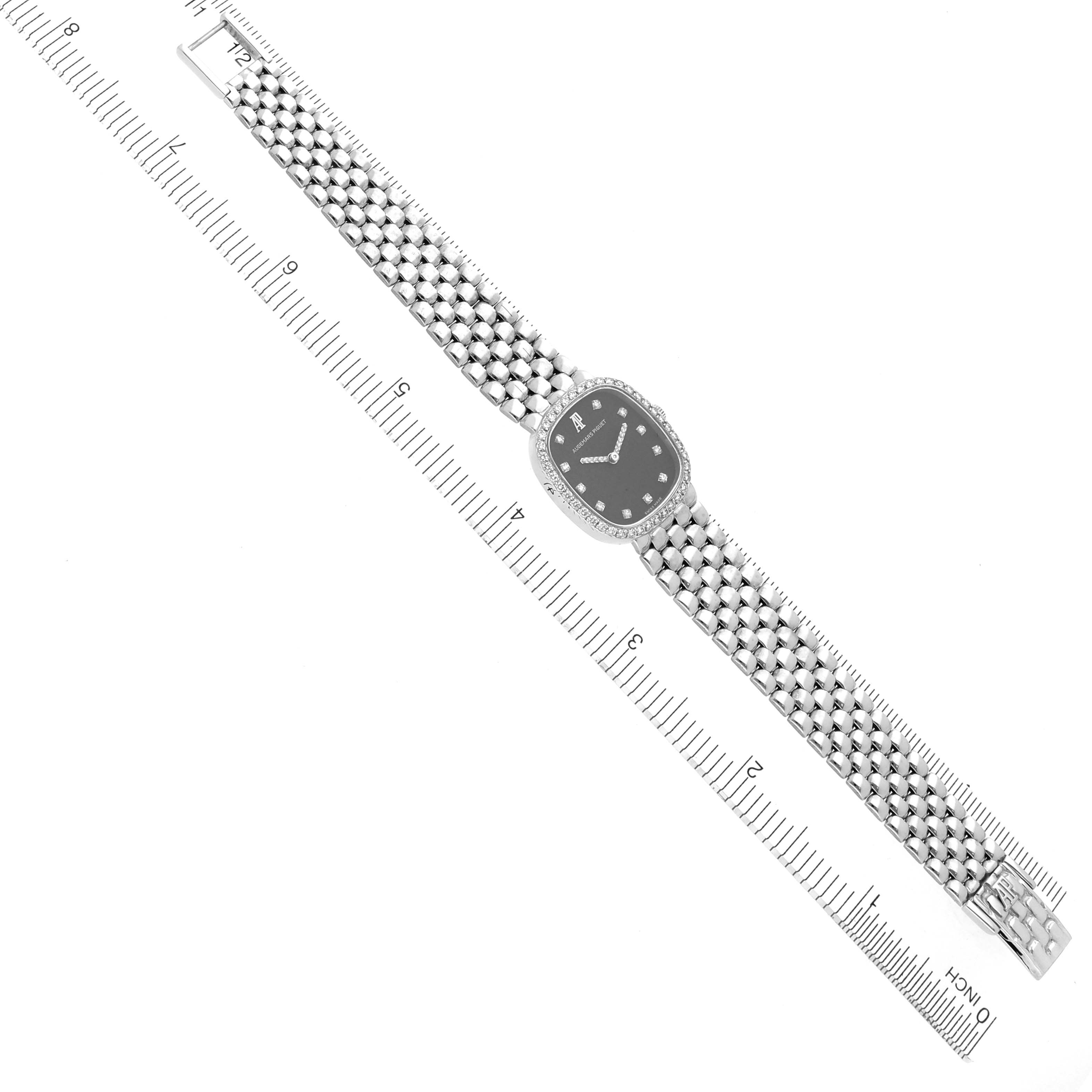 The Audemars Piguet Vintage Women's White Gold Black Dial Women's White Gold Black Dial watch is shown from a top-down angle, displaying its face and full metal bracelet.