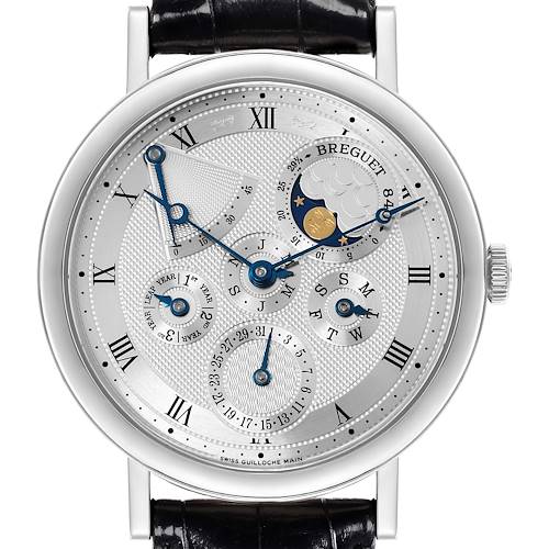 The Breguet Classique watch is shown from the front, highlighting its detailed multi-function dial and Roman numeral indices.