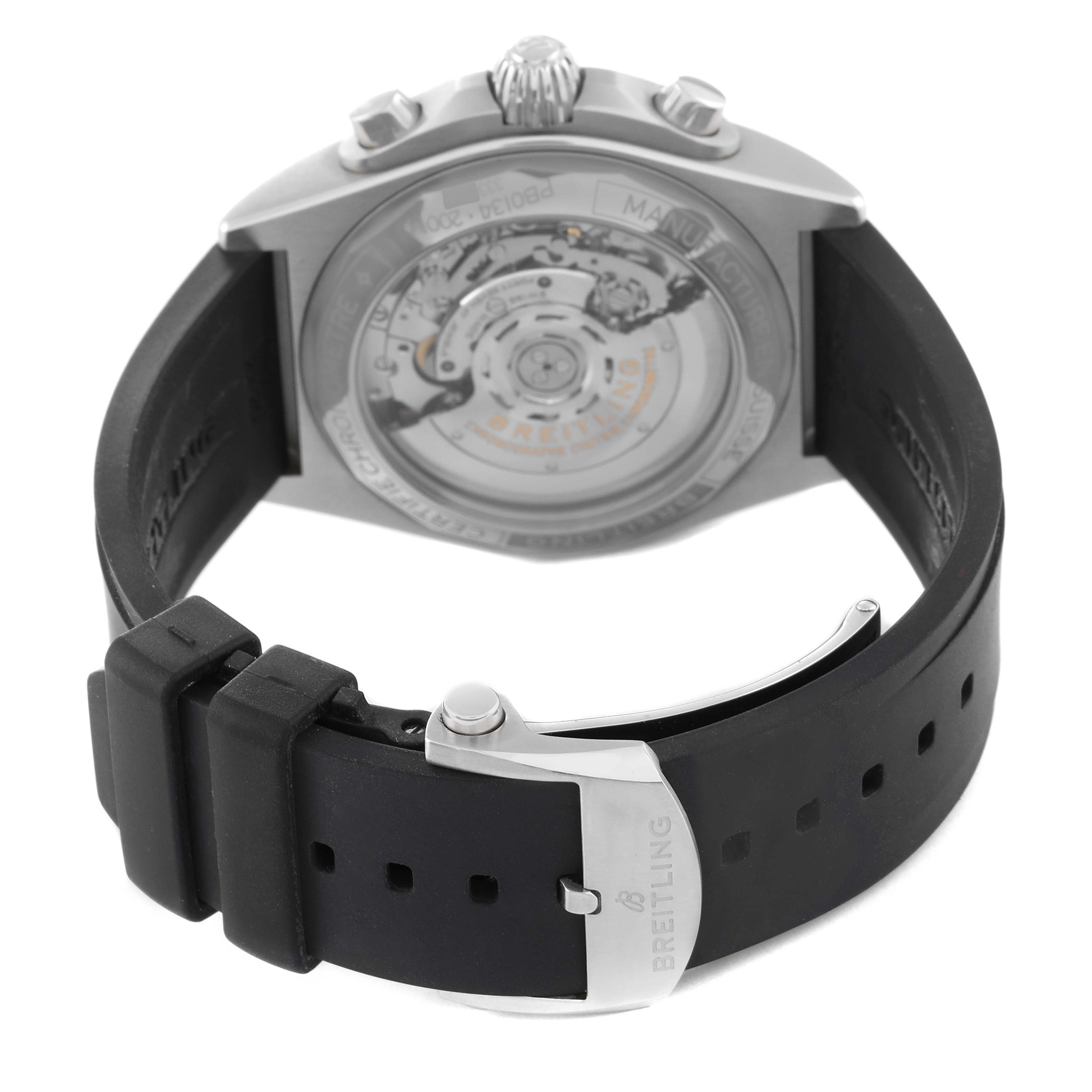 This Breitling Chronomat PB0134101C1S1 Men's Stainless Steel Blue Dial PB0134101C1S1 Men's Stainless Steel Blue Dial watch is shown from the rear, highlighting the transparent case back and black rubber strap with clasp.