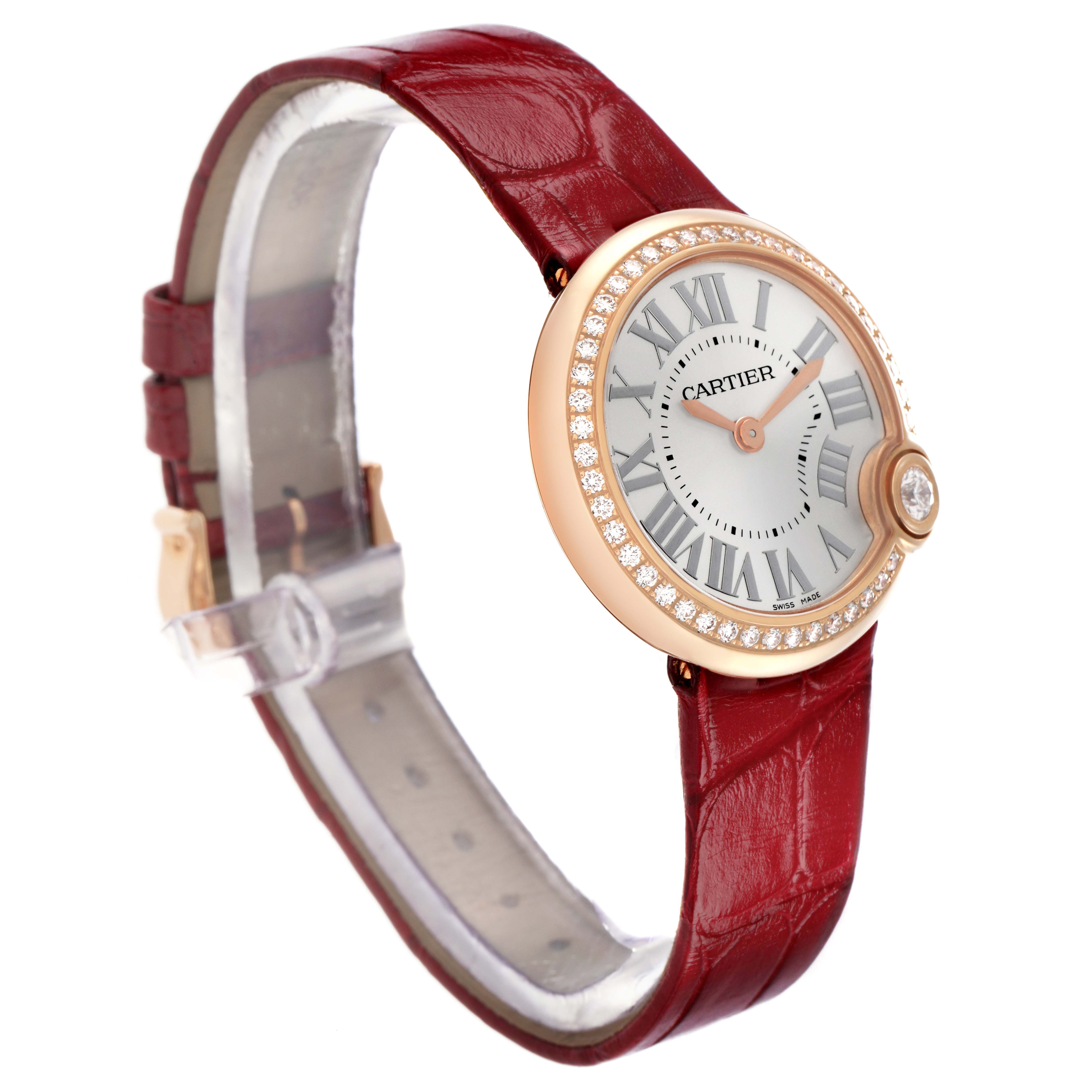 The Cartier Ballon Blanc WJBL0005 Women's Rose Gold Silver Dial watch is shown at a three-quarter angle, highlighting the face, diamond bezel, and red strap.