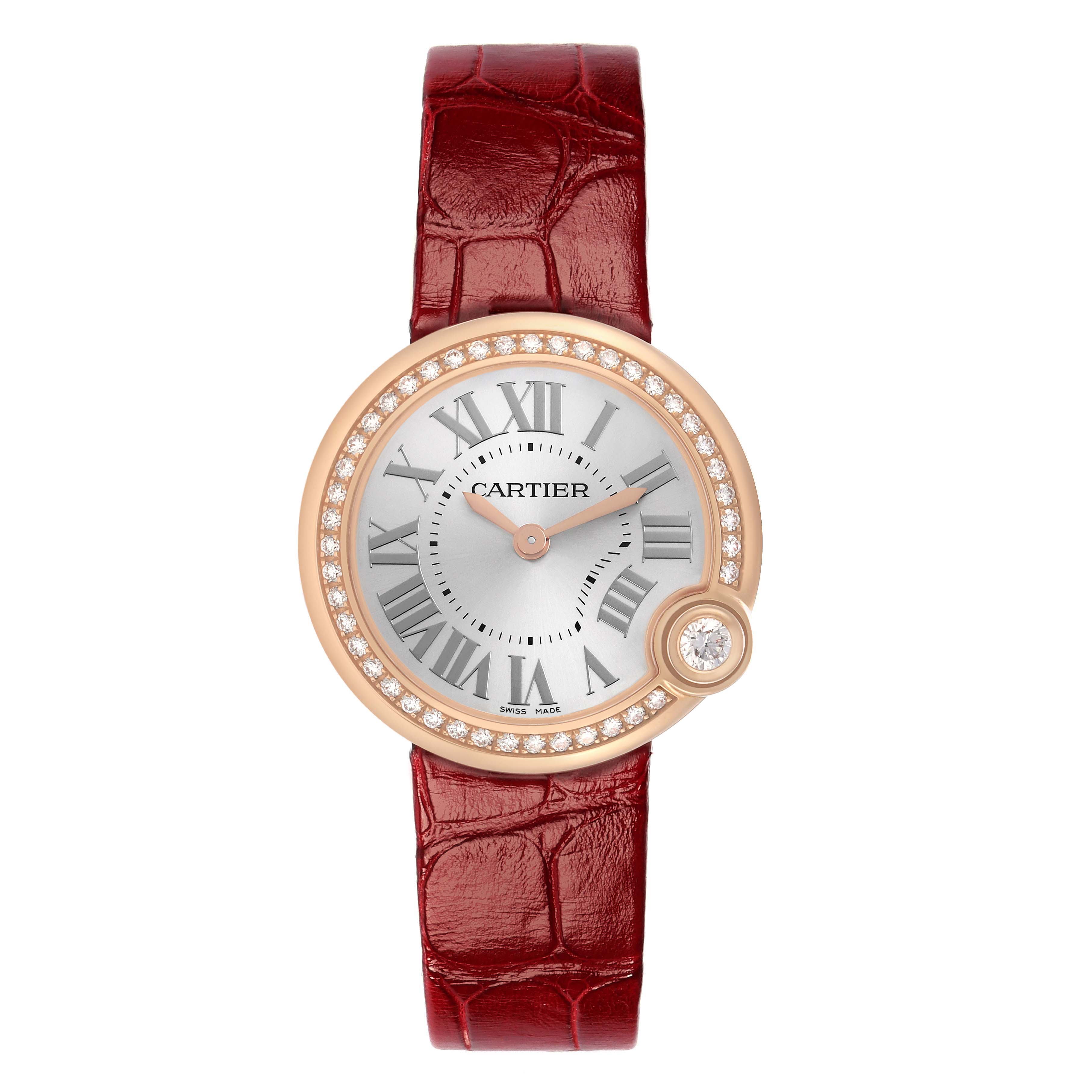 The Cartier Ballon Blanc WJBL0005 Women's Rose Gold Silver Dial watch is shown from a top-down angle, featuring a red strap and diamond-studded bezel.