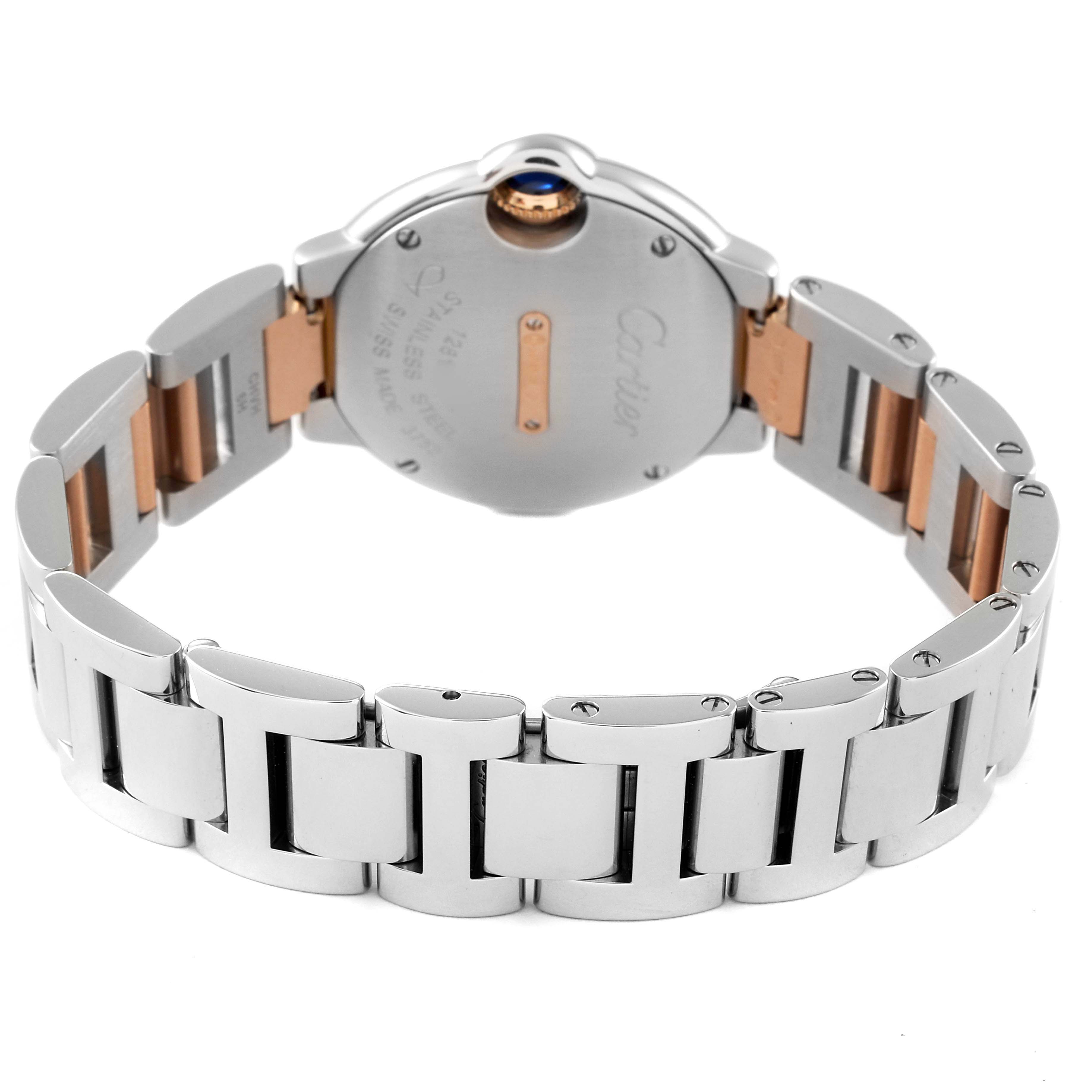 The image shows the back and bracelet of a Ballon Bleu watch by Cartier, highlighting the metal links and sapphire crown.