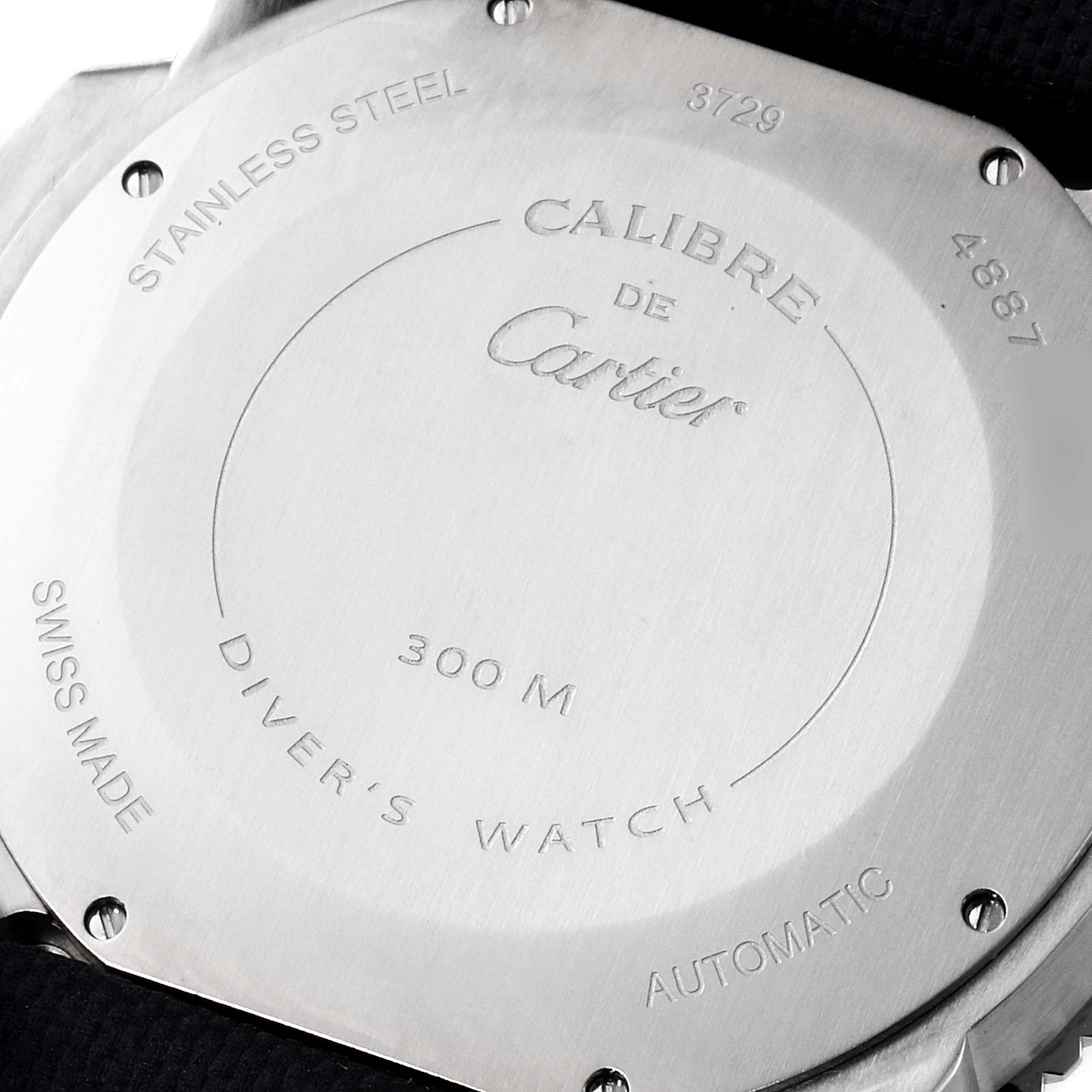 This image shows the back side of a Calibre de Cartier watch by Cartier, highlighting its stainless steel case, water resistance, and various inscriptions.