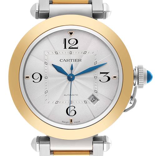 The Cartier Pasha watch is shown from the front, highlighting the dial, gold bezel, crown, and bracelet edges.