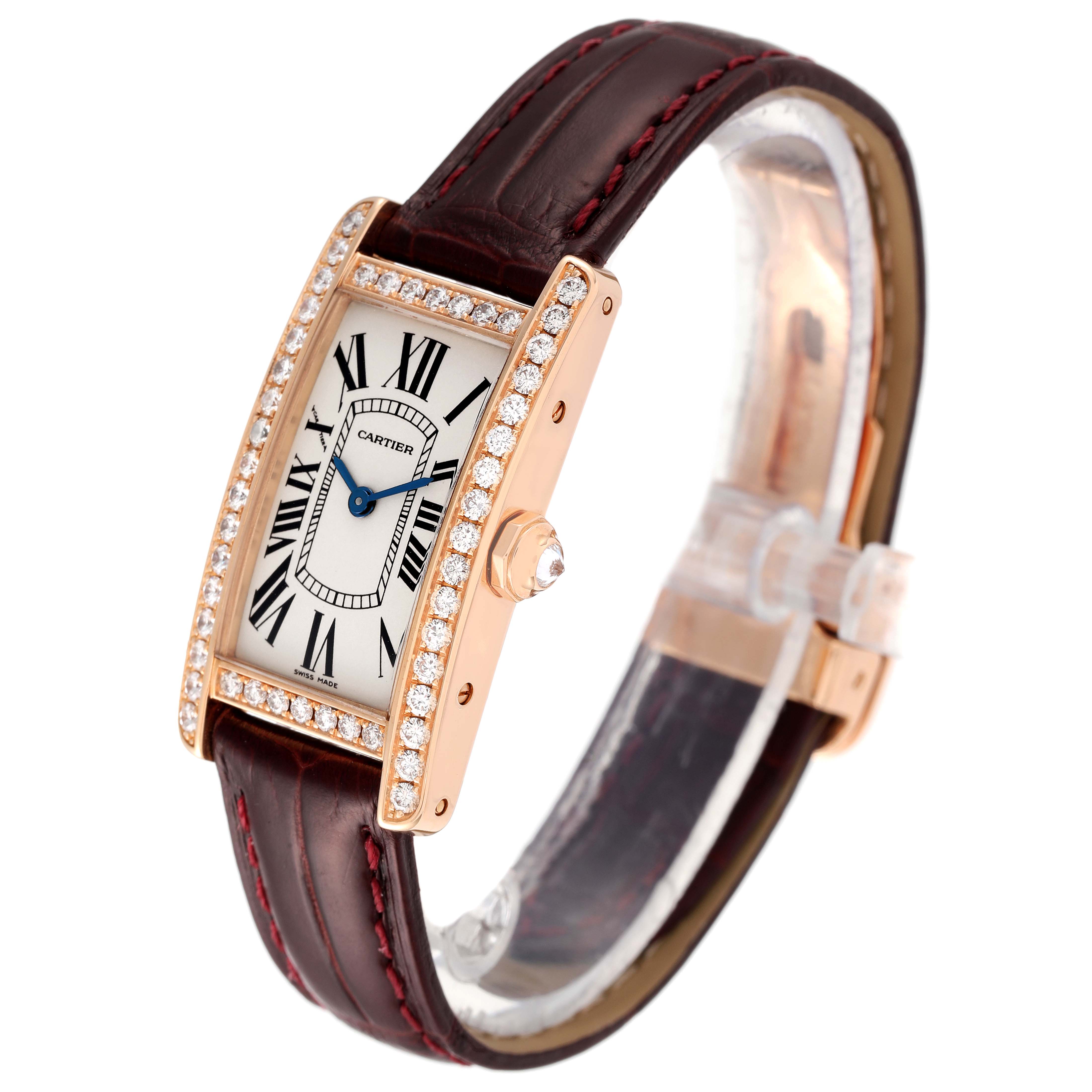 The image shows a Cartier Tank Americaine WJTA0002 Women's Rose Gold Silver Dial WJTA0002 Women's Rose Gold Silver Dial watch at an angle highlighting its face, diamond bezel, and brown leather strap.