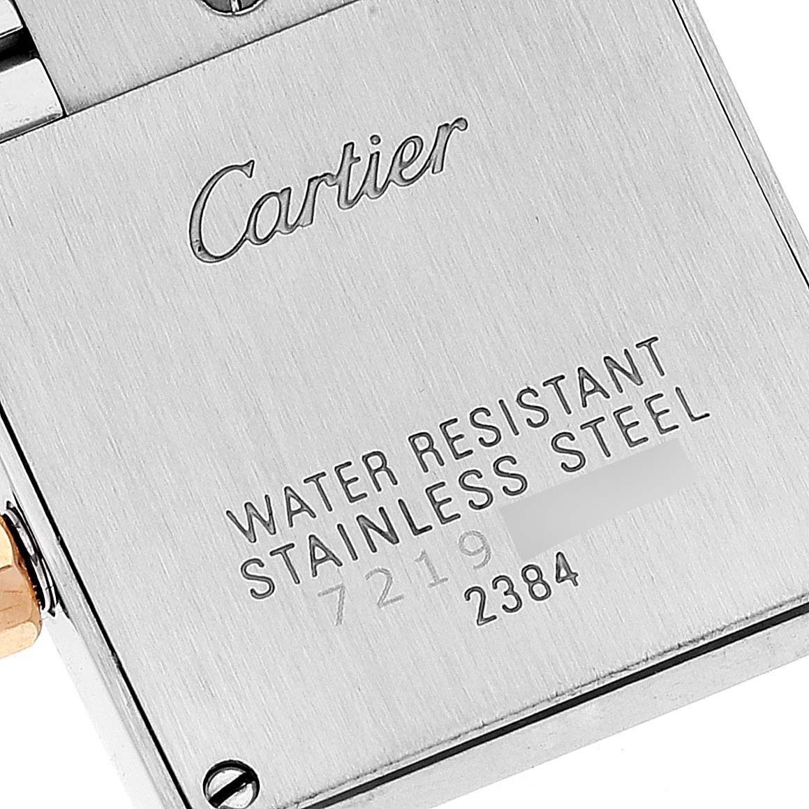The image shows the back of a Cartier Tank Française watch, highlighting the engraved logo and water-resistant stainless steel marking.