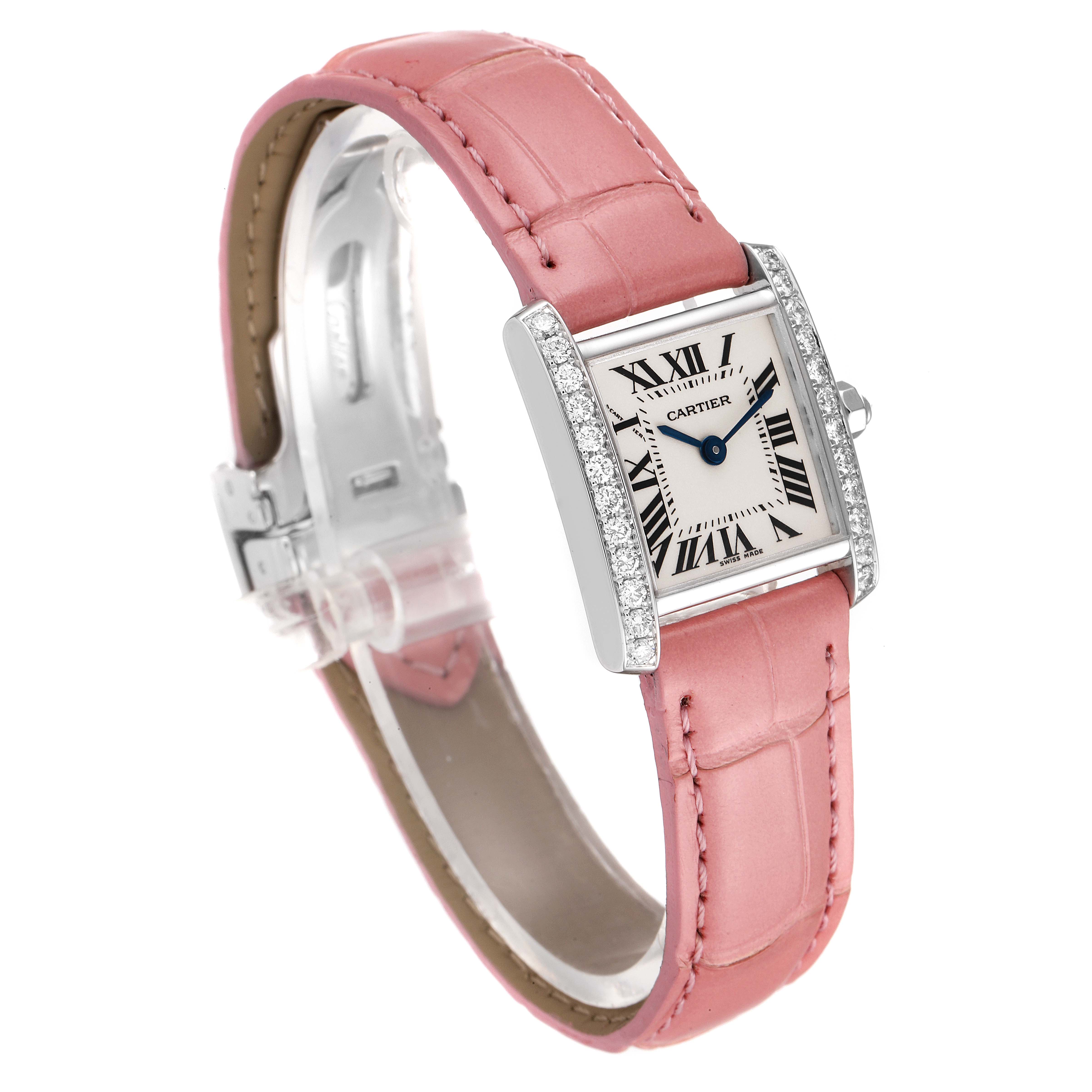 This side-angle view shows the Cartier Tank Française watch with a pink leather strap and diamond-studded rectangular case.